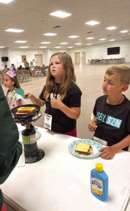 Campers at the 4-H Project Camp are shown cooking their own grilled cheese sandwiches for lunch, during day two of Project Camp on Tuesday at the Lamb County Ag Center. (Submitted Photo)