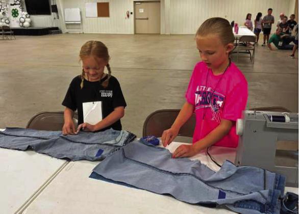 Campers at the 4-H Project Camp are shown sewing their first seams on their blue jean laundry bags, during day two of Project Camp on Tuesday at the Lamb County Ag Center. (Submitted Photo)