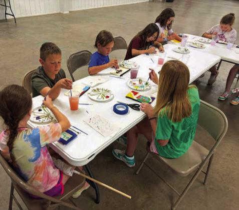 Campers at the 4-H Project Camp are shown painting a canvas bag as part of the fashion &amp;amp; interior design project, during day one of Project Camp on Monday at the Lamb County Ag Center. (Submitted Photo)