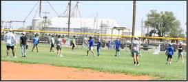 Olton Head Baseball Coach Matthew Ingle demonstrates how a relay throw should be received, during a drill to open the final day of his Basbeall Camp in June. (Staff Photo by Derek Lopez)