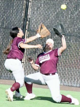 HANGING ON TO THE BALL – Littlefield right fielder, Alex Hernandez avoids a collision with center fielder, Tricia Torres, long enough to make a catch and hold on to the ball in right-center field for an out, during the Lady Cats’, 10-1, loss to Lamesa in their second meeting of district play on Friday. (Staff Photo by Derek Lopez)