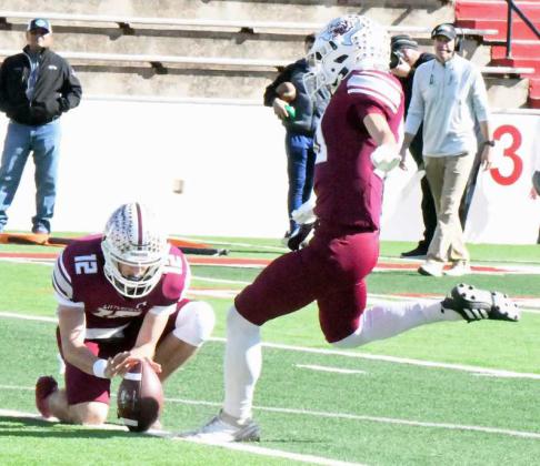 Littlefield senior kicker, Adam MacDonald (30), drills the PAT to tie the game, 7-7, in the first quarter of the Wildcat’s 3A Regional Play-off game in Sweetwater on Friday. (Staff Photo by Derek Lopez)