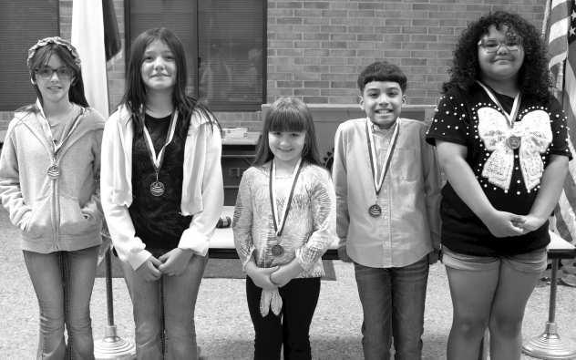 Fourth-grade students Inara Devaughn, Aaron Garcia, Reimi Pearson, Perla Talamantes and Noemy Talamantes Mendoza receive the Most Improved Writers award at the Rotary Club of Littlefield meeting on April 2, 2026. (Photo by Madison Vidales)