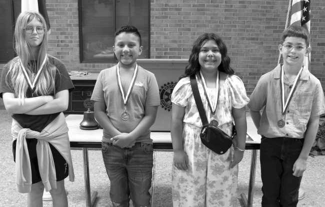 Fifth- grade students Braxton Lopez, Jaylah Minjarez, Dominic Basquez and Erin Spafford receive the Most Improved Reasoners award at the Rotary Club of Littlefield meeting on April 2, 2026. (Photo by Madison Vidales)
