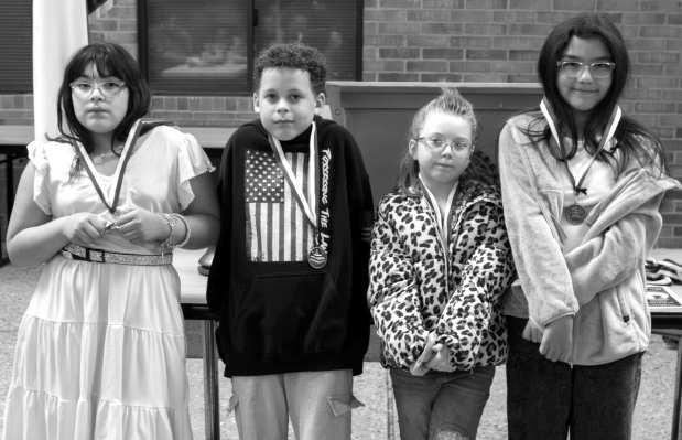 Third-grade students Gianna Ferrumpau, Frankie Espinoza, Carter Green and Esperanza Carrizales recieve the Most Improved Readers award at the Rotary Club of Littlefield meeting on April 2, 2026. (Photo by Madison Vidales)
