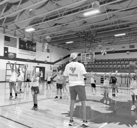 Campers at the Fillie Youth Basketball Camp work on shooting form with Olton varsity head girl’s basketball Coach Jay Gorman, during the first day of camp on Monday, June 1. (Submitted Photo)