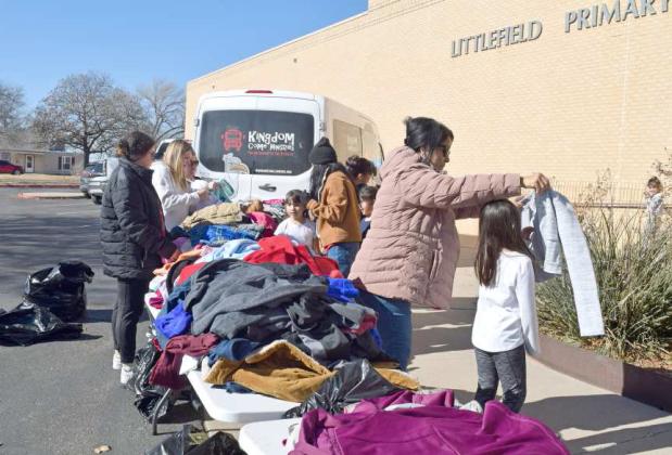 YOUNGSTERS at Littlefield Primary school being helped in selecting a new coat by volunteers with Kingdom Ministries of Lubbock and primary staff during the Charlie’s Coats 4 Kids annual coat drive on Wednesday, Dec. 14, 2022. (Photo byAnn Reagan)