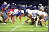 The Olton Mustangs held their annual Midnight Madness intersquad scrimmage Friday night into Saturday morning. Shown is the offensive and defensive lines set to square off. ( Staff Photo by Derek Lopez)