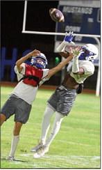 Olton receiver, Rylan Holmes, leaps up for a pass near the home sideline, during their Midnight Madness scrimmage Friday night. (Staff Photo by Derek Lopez)