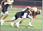 A Sudan defender makes an open field tackle, during their intersquad scrimmage Saturday night at Hornet Stadium. (Staff Photo by Derek Lopez)