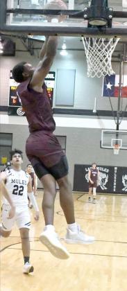THROWING DOWN THE SLAM – Littlefield senior forward, Tyree Jones (54), pokes away a steal and gets out in front on a breakaway throwing down a two-hand slam dunk, during the first half of the Wildcats’ victory over Muleshoe on Tuesday on the road. (Staff Photo by Derek Lopez)