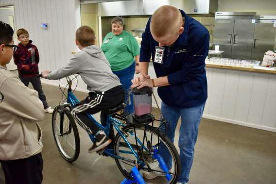 Jaden Burt- Educated about the importance of exercise, the USDA MyPlate, 4-H projects/programs. The kids were able to ride a stationary bike that powered a mixer and sampled the strawberry smoothies that they made. (Submitted Photo)