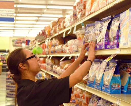 SERENA CHARLES carefully sets the shelves at United Supermarket of Littlefield. Selena is a student in the Texas Workforce Commission’s SEAL program. (Photo by Ann Reagan)