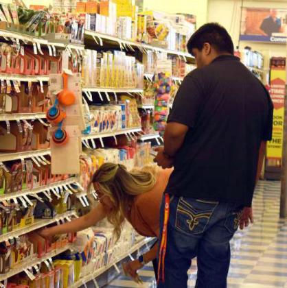 GUILLERMO QUENTANA learns how to stock under the tutelage of Jennifer Cordero. (Photo by Ann Reagan)