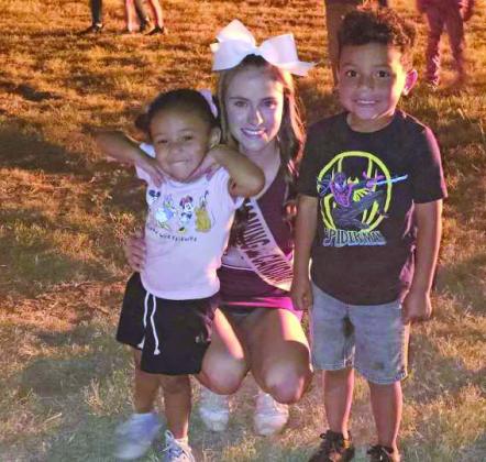 Littlefield cheerleader Bryndle Ray with future Wildcat and Lady Cat Jaden and Natalia Lopez at the Bonfire. (Staff Photo by Derek Lopez)