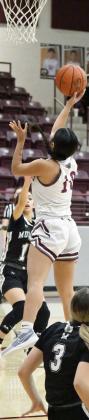 Littlefield junior, Nevaeh Esquibel (10), gets around her defender for a lay-up, during the first half of the Lady Cats’ victory over Muleshoe on Friday. (Staff Photo by Derek Lopez)