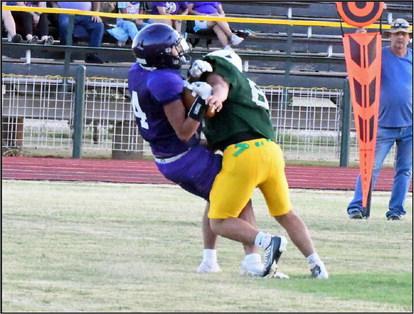 Springlake-Earth’s Timothy Tovar delivers the boom on the Lorenzo ball carrier. during their scrimmage on Friday evening at Wolverine Stadium. (Staff Photo by Derek Lopez)