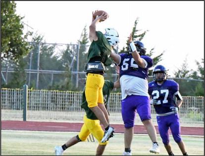 Springlake-Earth’s Froylan Agundiz picks off Lorenzo to end their scrimmage on defense on Friday evening at Wolverine Stadium. (Staff Photo by Derek Lopez)