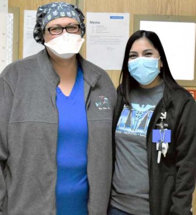 NURSES WHO DEAL WITH THE COVID VIRUS—These are two of the three nurses that were interviewed by Krista Carpenter, concerning their jobs at the Emergency Room of Lamb Healthcare Center. Their interviews reveal their personal emotional concerns, as they work with patients. Shown are nurses, left to right, Rosemary Franco and Miranda Torrez. ER Tech, Deanna Duran, who gets patient information and registered, did not want to have her picture taken. (Photo by Krista Carpenter)