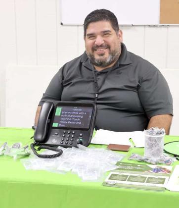 Mr. Daniel Pena, Jr. was demonstrating Caption Call telephone systems for the hearing impaired at the Health Fair on Saturday, August 24, 2024. (Photo by Ann Reagan)