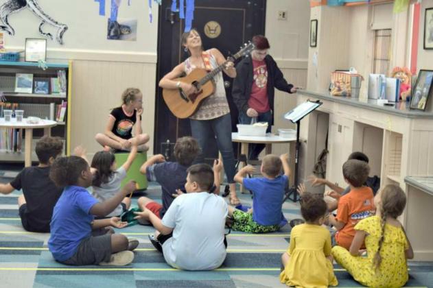 TONI MEREDITH entertains the young participants of the Lamb County Library Summer Reading Program as they arrive at the library. The program will run every Wednesday afternoon from 2 p.m. until 4 p.m. through the month of June. (Photo by Ann Reagan)