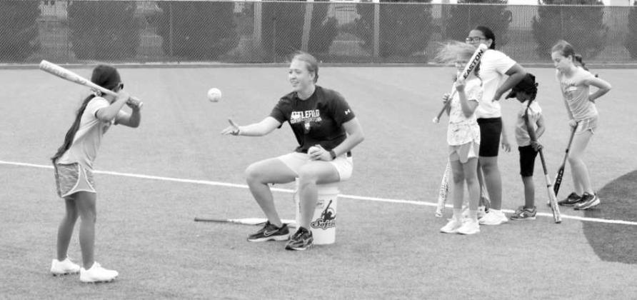 Littlefield Head Softball Coach Ally Oyanguren works with campers during drills at the Littlefield Youth Softball Camp on June 18 at the Lady Cat Softball Field in Littlefield.