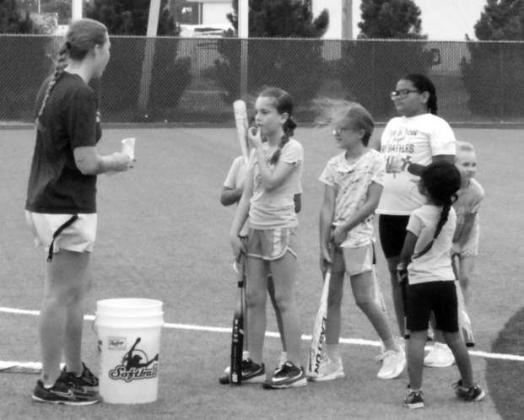 Head Coach Ally Oyanguren gives feedback to a camper during drills at the Littlefield Youth Softball Camp on June 18 at the Lady Cat Softball Field in Littlefield.