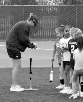 Assistant Coach Suzanne Perry instructs campers during a drill at the Littlefield Youth Softball Camp held June 18 in Littlefield.