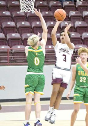 Ryan Williams (3) puts up a floater over Idalou’s Logan Mennel (0), during the first half of the Wildcats’, 58-52, victory at Wildcat Gym in Littlefield on Tuesday. (Staff Photo by Derek Lopez)