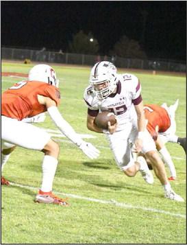 BRINGING THE BOOM - Littlefield junior quarterback, Chip Green, takes a quarterback keeper around the left side lowering his shoulder on the sideline and running through a Brownfield defender, during the second half of the Wildcats road victory last Friday to close out the pre-district schedule. (Staff Photo by Derek Lopez)