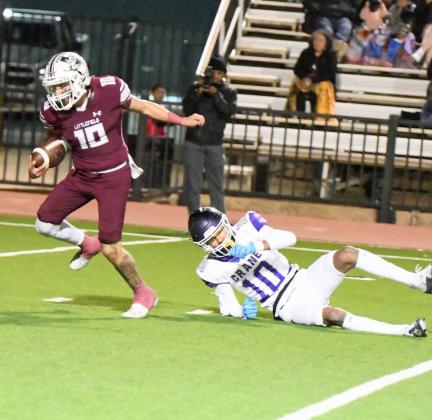 Littlefield senior running back, Ian Mendez, breaks a tackle from Crane’s Lucas Bernard, on his way to a 43-yard touchdown run to open the scoring for the Wildcats, during the first quarter of their, 59-0, 3A Area Championship victory over the Golden Cranes in Lamesa on Friday night. (Staff Photo by Derek Lopez)