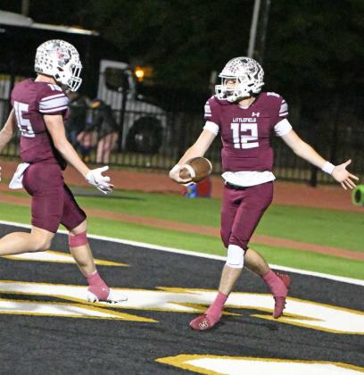 Littlefield senior, Chip Green (12), and senior, Bradyn Redman (15), celebrate in the endzone after a 77yard punt return touchdown from Green, during the second quarter of the Wildcats’3AArea Championship win over Crane in Lamesa on Friday. (Staff Photo by Derek Lopez)
