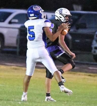 Amherst’s Oscar Contreras, pulls down an interception to close out the first quarter of the Bulldog’s, 30-0, victory over Dawson on the road Thursday night. (Staff Photo by Derek Lopez)