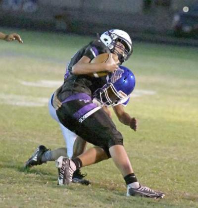 Amherst’s Jose Fiero, makes an open field tackle on the sideline to bring the Dawson ball carrier down, during the second quarter of the Bulldog’s, 30-0, victory over Dawson on the road Thursday night. (Staff Photo by Derek Lopez)