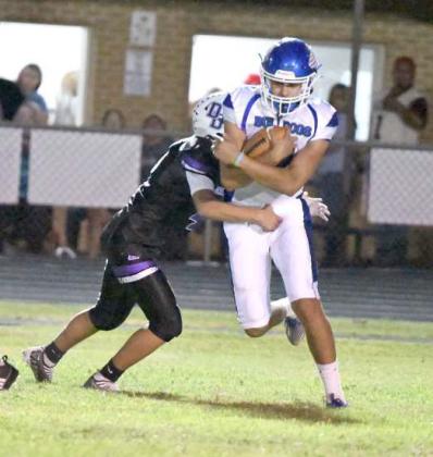 Amherst’s Joel Garcia, pulls shakes off a would-be Dawson tackler, during an interception return on Thursday during the Bulldog’s, 300, victory over Dawson on the road Thursday night. (Staff Photo by Derek Lopez)