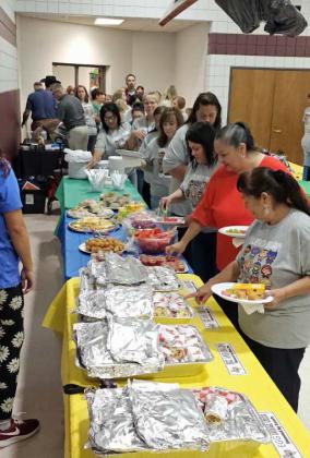 Littlefield ISD faculty and staff filed in monday morning, picking up some breakfast that was donated, during the Littlefield ISD Staff Breakfast sponsored by the Chamber of Commerce. (Staff Photo by Derek Lopez)