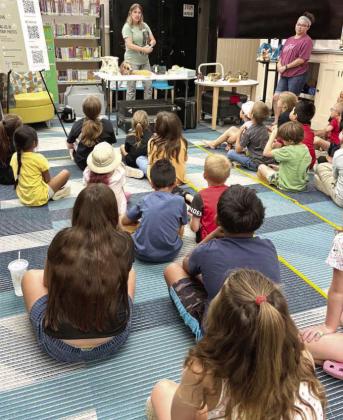 Kendra Wallace of the Museum of Texas Tech University speaks to students during a paleontology presentation at the Lamb County Library on June 17. (Photo by Leon Szaniszlo)