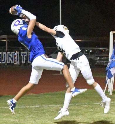 TWO-POINT CONVERSION - Olton’s Nate Urbina (8), catches a two-point conversion over the Vega defender, during the second half of the Mustang’s homecoming victory last Friday. (Staff Photo by Derek Lopez)