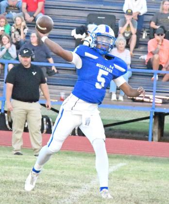 POSITIVE YARDS - Olton quarterback, Raymond Ramirez, drops back and completes a pass to his right to Sebastian Sparkman to pick up some yards for the Mustangs, during the first quarter of their homecoming victory over Vega last Friday at Mustang Stadium. (Staff Photo by Derek Lopez)