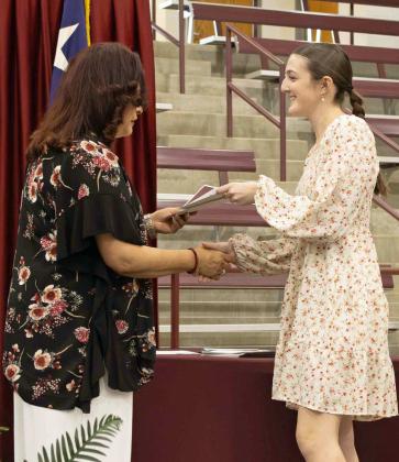Devyn Crouch receives the $250 Hillcrest Funeral Home Scholarship at the Littlefield High School Scholarship Awards Ceremony on May 20, 2025. Crouch additionally received the $500 Littlefield Classroom Teachers Association Scholarship, the $250 band scholarship and the $8,000 Rotary Club Scholarship. (Staff Photo by Madison Vidales)