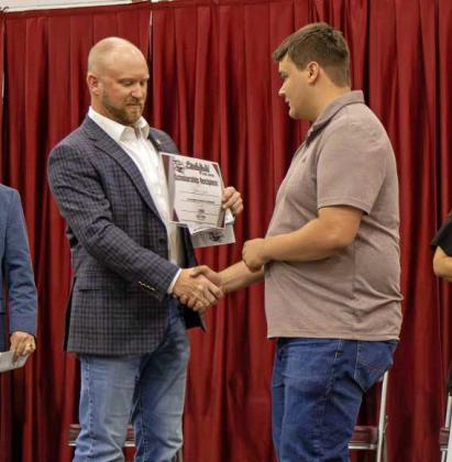 Steven Lowe receives the $1,000 The Bryson McCarty Memorial Scholarship at the Littlefield High School Scholarship Awards Ceremony on May 20, 2025. Lowe additionally received the Woodmen of the World, Ed McCanlies Memorial Scholarship for $500. (Staff Photo by Madison Vidales)