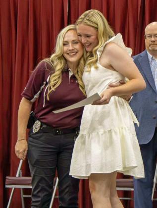 Tonya Saenz presents Audrey McKinnon with the Littlefield EMS scholarship at the Littlefield High School Scholarship Awards Ceremony on May 20, 2025. McKinnon additionally received the Capital Farm Credit and Littlefield Ex-Students Association scholarships. (Staff Photo by Madison Vidales)