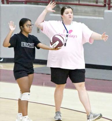 Littlefield Head Volleyball Coach Kaylee Edgemon coaches up one of her players on serving, during their first day of two-a-day practices on Monday at Wildcat Gym. (Stsaff Photo by Derek Lopez)