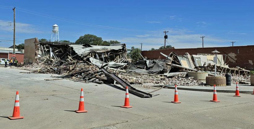 The old Dollar General building in Littlefield collapsed earlier this week on Phelps Ave. Shown are crews cleaning up the debris of the fallen building on Thursday morning. (Staff Photo by Derek Lopez)