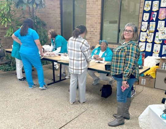 Kim Moss and Barbara Colbert are cashing out customers at the Lamb Healthcare Center Auxiliary annual Bake Sale and Bazaar. Margaret Duran, right, is in line to make a purchase. The Bazaar was held on Tuesday, Nov. 21 and Wednesday, Nov. 22 in the Atrium of the Lamb Healthcare Center. (Submitted Photo)