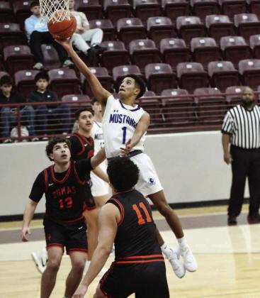 Olton’s Sebastian Sparkman (1), gets to the basket for a lay-up, during the first half of the Mustang’s victory over Dumas Tuesday night in the Wildcat Clasic Semi-Finals. (Staff Photo by Derek Lopez)