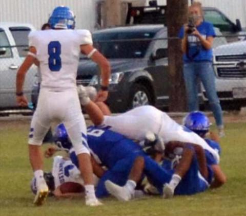 PILE-UP WITH BULLDOGS ON BOTTOM—Action was swift Friday evening, Sept. 25, 2020 during Amherst High School’s Homecoming Game, when the Amherst Bulldogs (in blue) and the Wildorado Mustangs (dressed in white) fought hard to come out the winner. The Bulldogs held their turf, but the Mustangs managed to come out the winner, by only one point (23 to 22). (Staff Photo by Joella Lovvorn)
