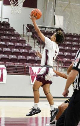 Littlefield senior, Ryan Williams (3), gets to the basket for a layup, during the first half of their season-opener against the Tigers on Tuesday at Wildcat Gym. (Staff Photo by Derek Lopez)