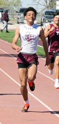 Kam McCarty blazes down the track for Littlefield in the varsity boy’s 100-meter dash. (Staff Photo by Derek Lopez)