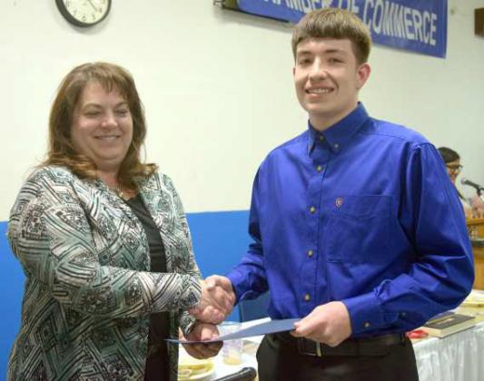 Jennifer Sawyer, President of the Amherst Chamber of Commerce presented Senior Isaac Herrera the Certificate of Scholarship at the Amherst Chamber of Commerce Banquet held Tuesday, March 28, 2023. (Photo by Ann Reagan)